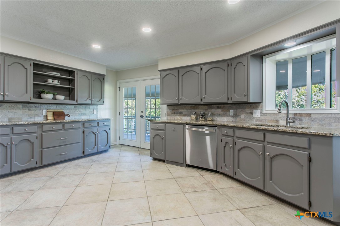 608 Ridgecrest Drive Salado, TX 76571 - Photo 13 of 43 a kitchen with stainless steel appliances granite countertop a stove sink and cabinets