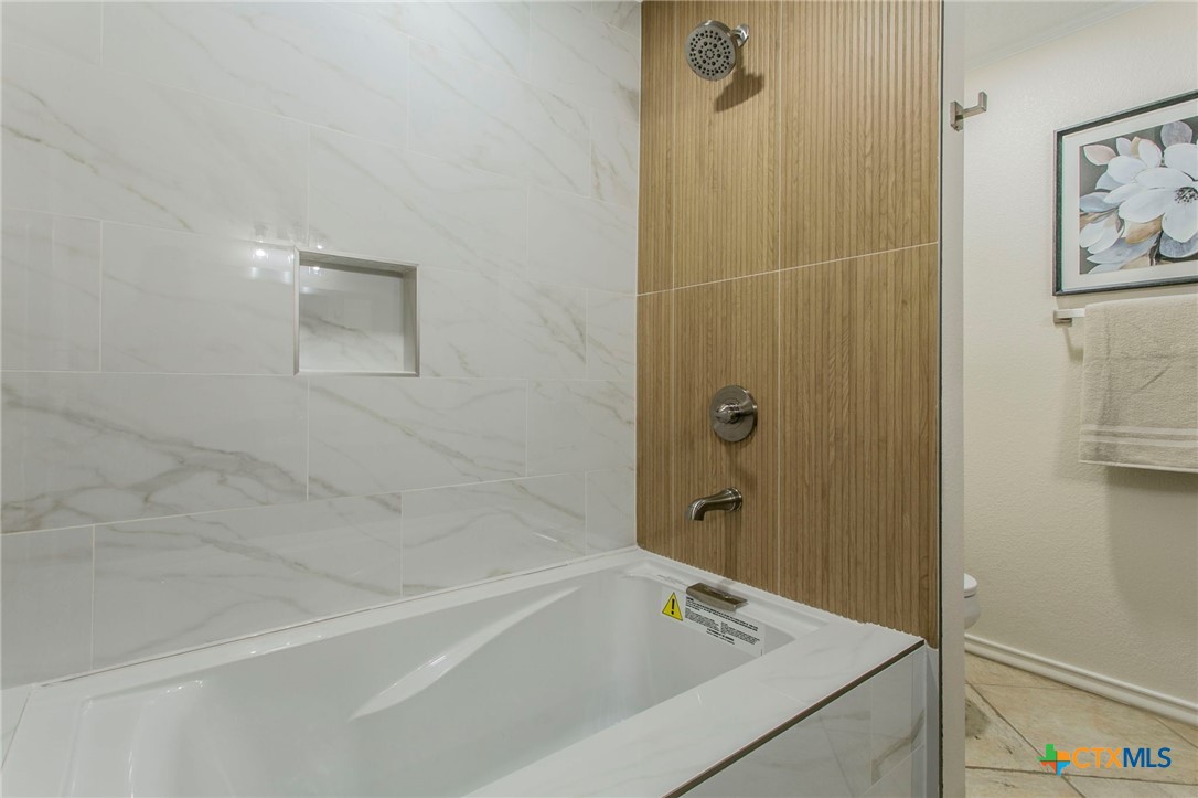 608 Ridgecrest Drive Salado, TX 76571 - Photo 19 of 43 a bathroom with a bathtub and shower