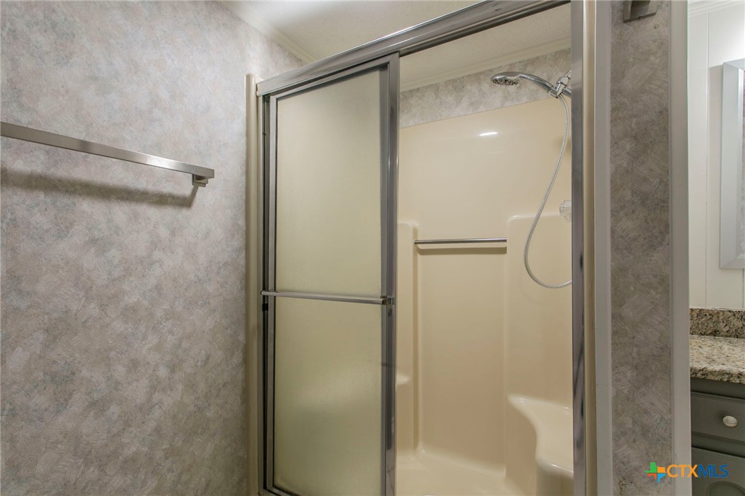 608 Ridgecrest Drive Salado, TX 76571 - Photo 20 of 43 a bathroom with a glass shower door
