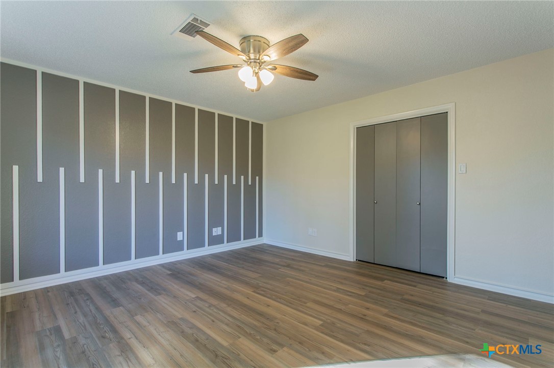 608 Ridgecrest Drive Salado, TX 76571 - Photo 24 of 43 an empty room with wooden floor and windows