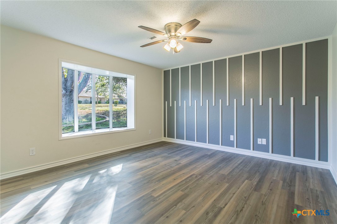 608 Ridgecrest Drive Salado, TX 76571 - Photo 25 of 43 a view of an empty room with a window and wooden floor