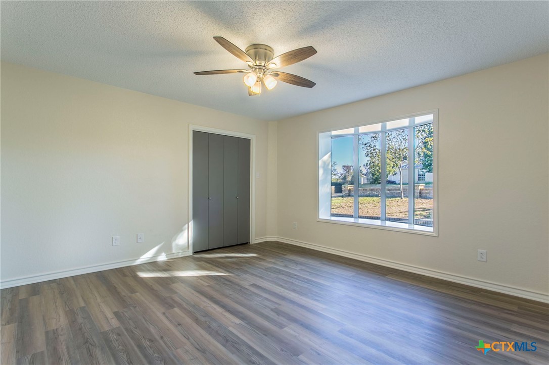 608 Ridgecrest Drive Salado, TX 76571 - Photo 30 of 43 a view of an empty room with wooden floor and a window
