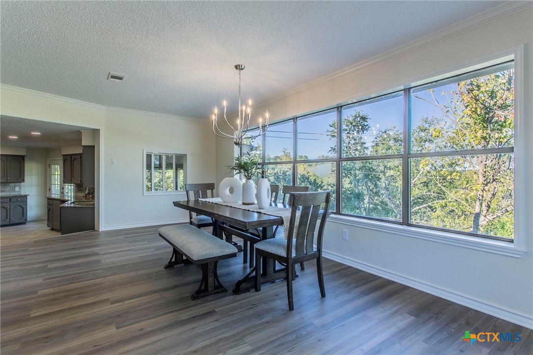 608 Ridgecrest Drive Salado, TX 76571 - Photo 9 of 43 a view of a dining room with furniture window and wooden floor