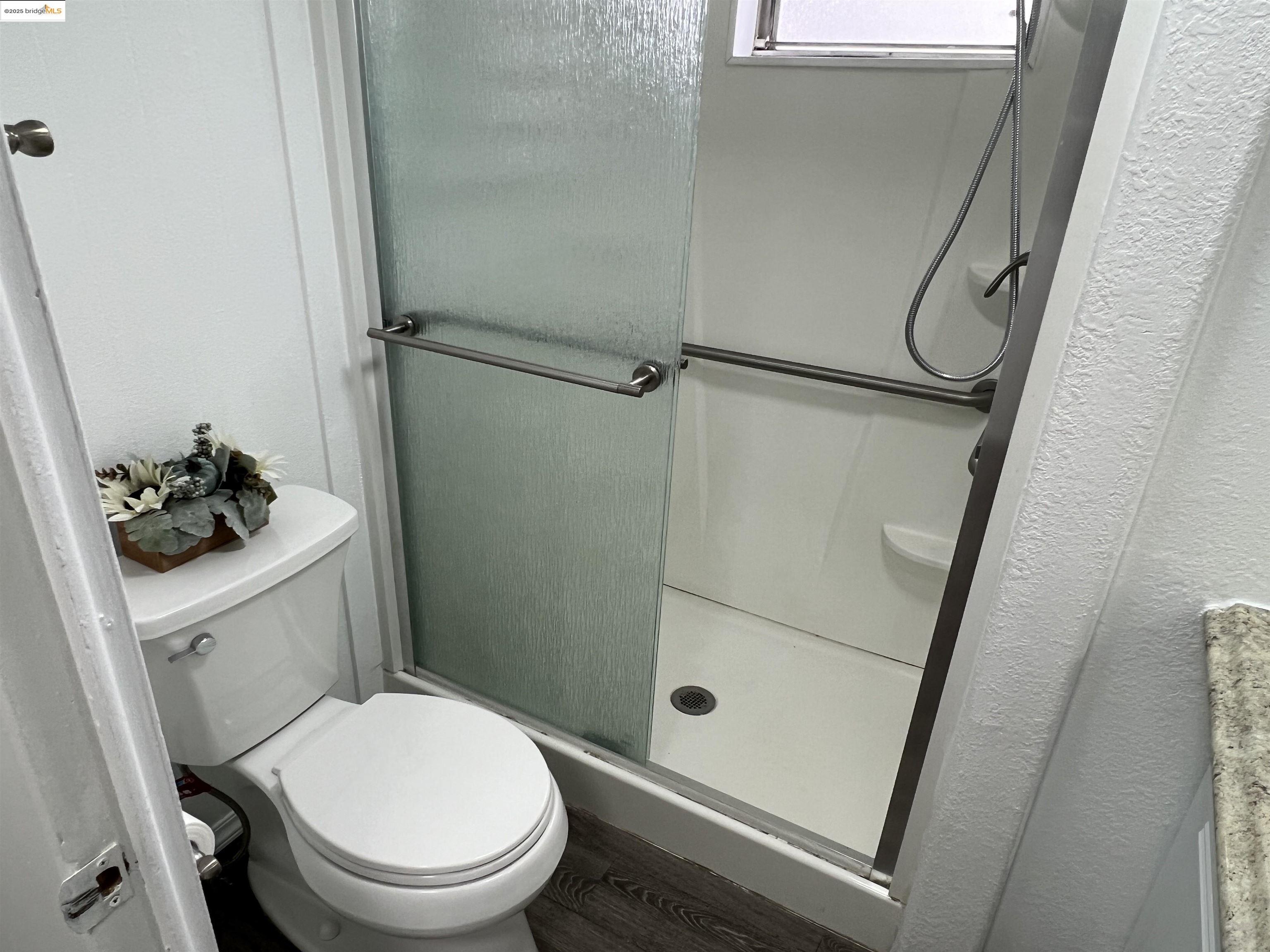 210 West Cypress Road, Unit 1 Oakley, CA 94561 - Photo 11 of 16 a bathroom with a toilet and a shower