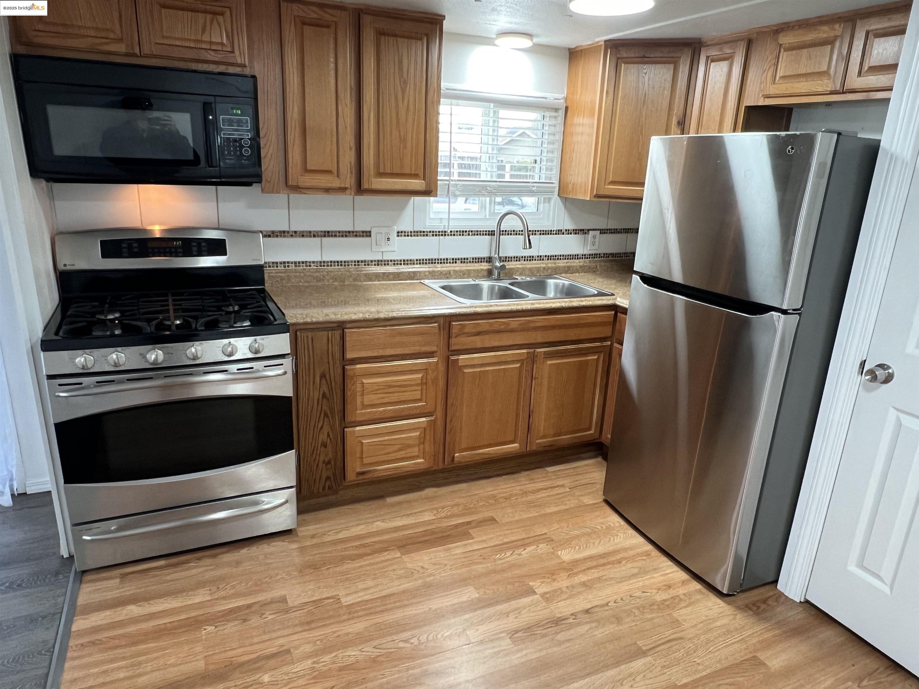 210 West Cypress Road, Unit 1 Oakley, CA 94561 - Photo 8 of 16 a kitchen with granite countertop a refrigerator stove and microwave