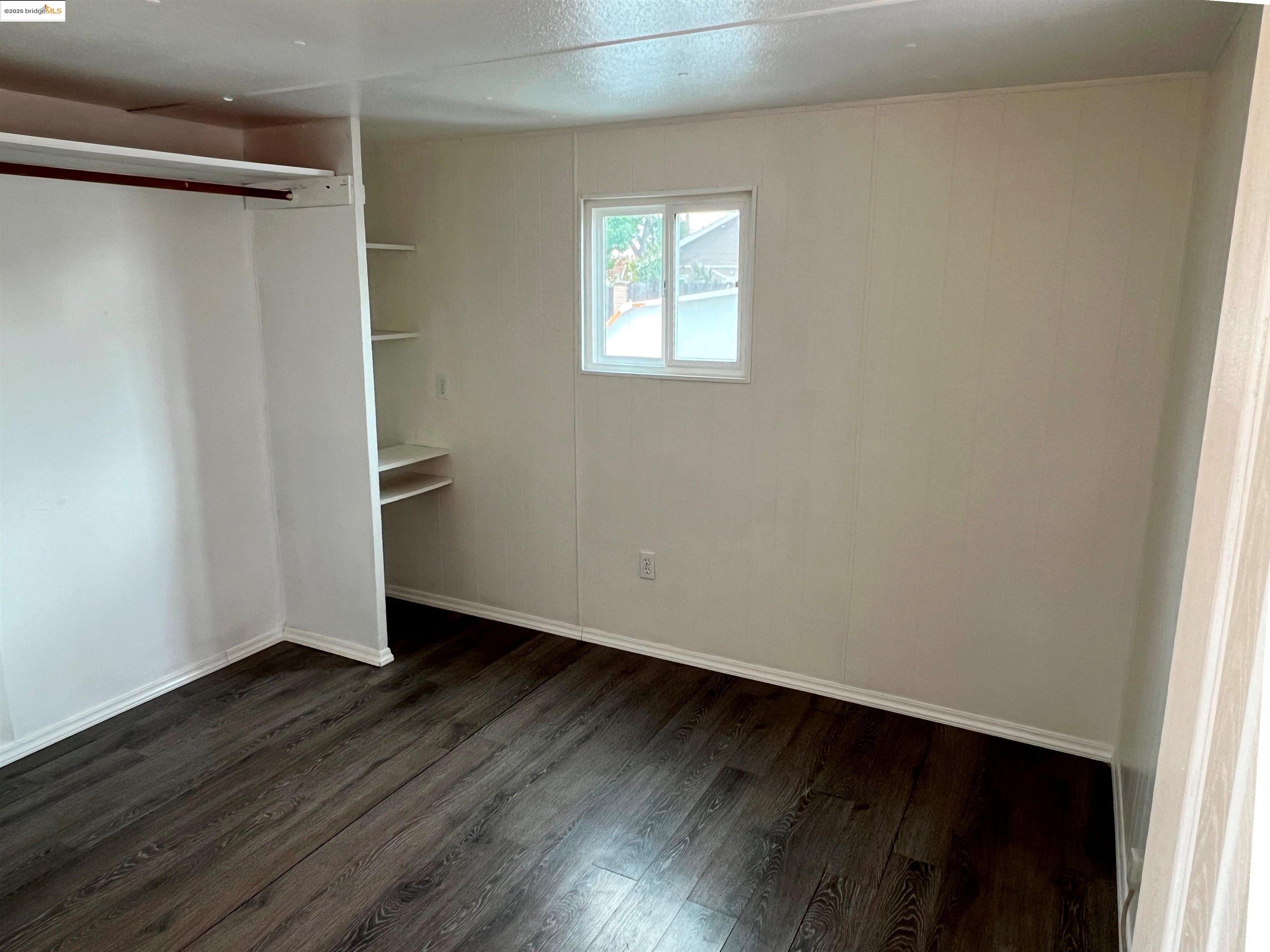 210 West Cypress Road, Unit 1 Oakley, CA 94561 - Photo 9 of 16 an empty room with wooden floor and windows