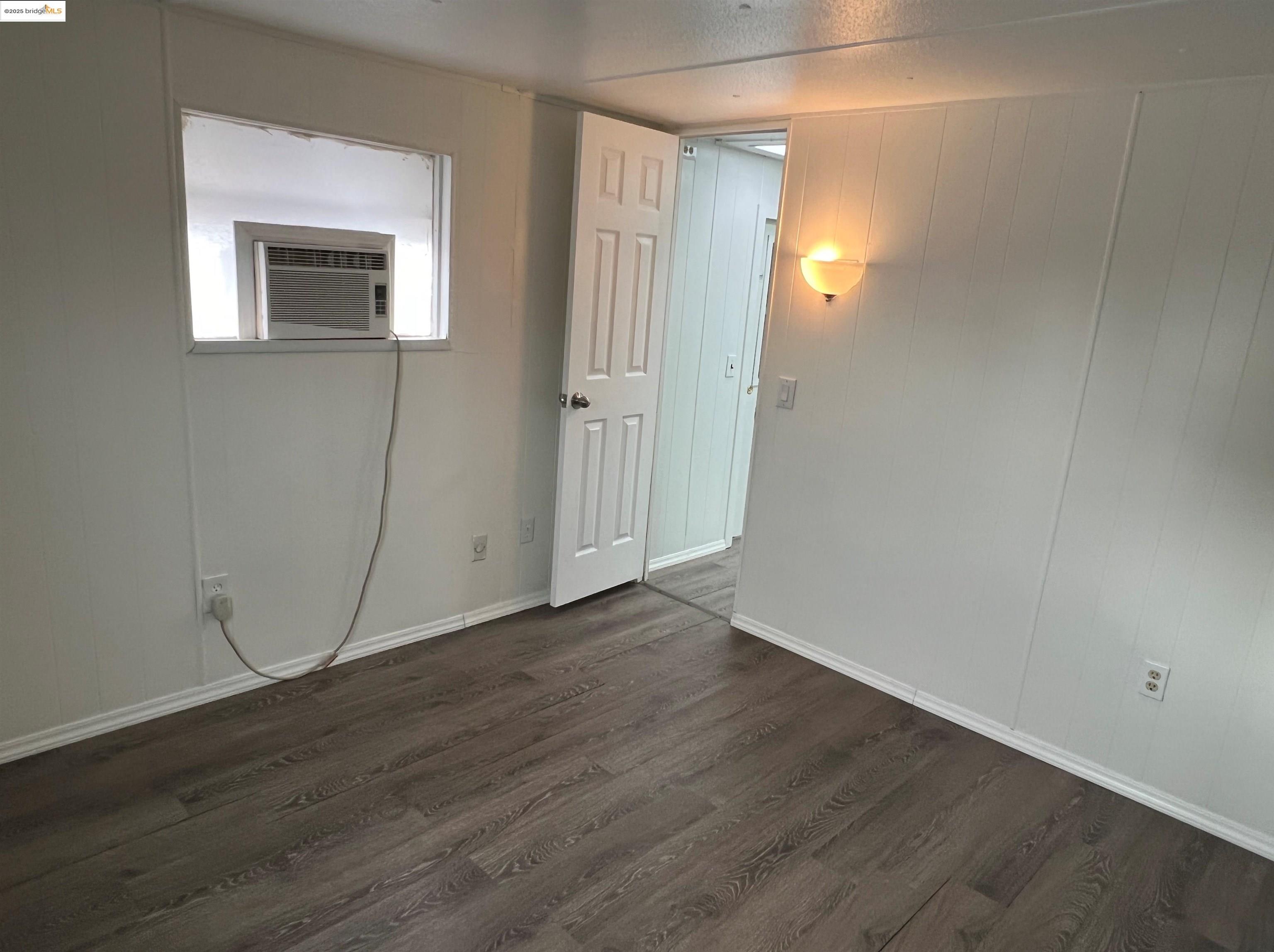 210 West Cypress Road, Unit 1 Oakley, CA 94561 - Photo 10 of 16 a view of an empty room with wooden floor and a window