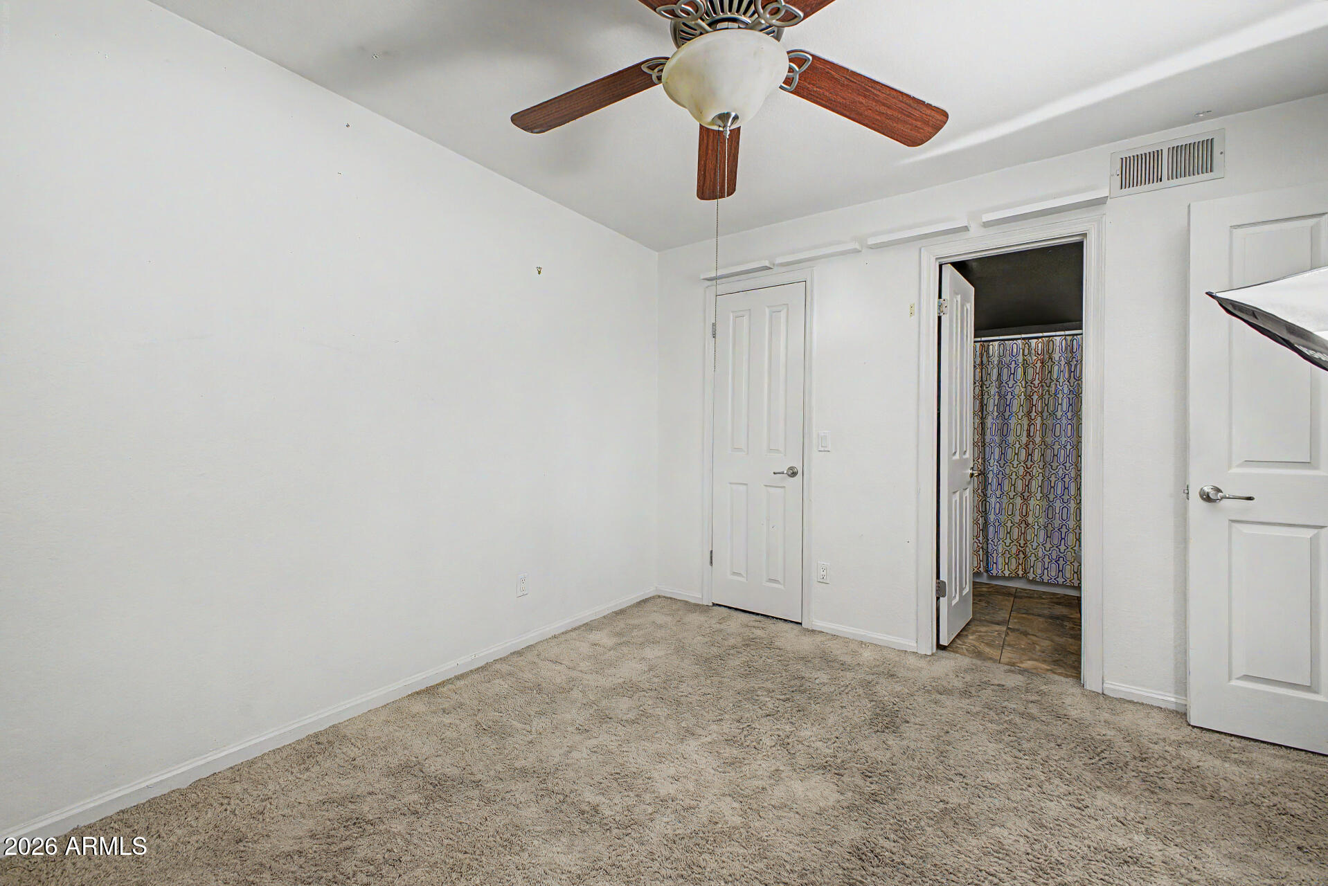 200 East Southern Avenue, Unit 224 Tempe, AZ 85282 - Photo 19 of 30 an empty room with closet and a chandelier fan