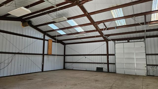 a view of an empty room with a ceiling fan