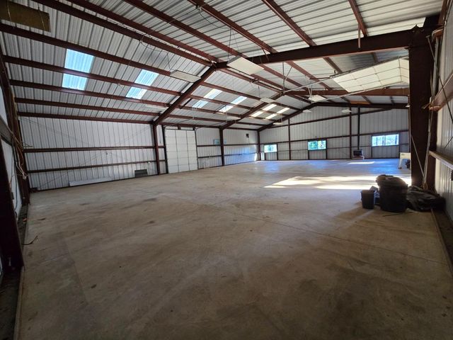 a view of empty room with refrigerator