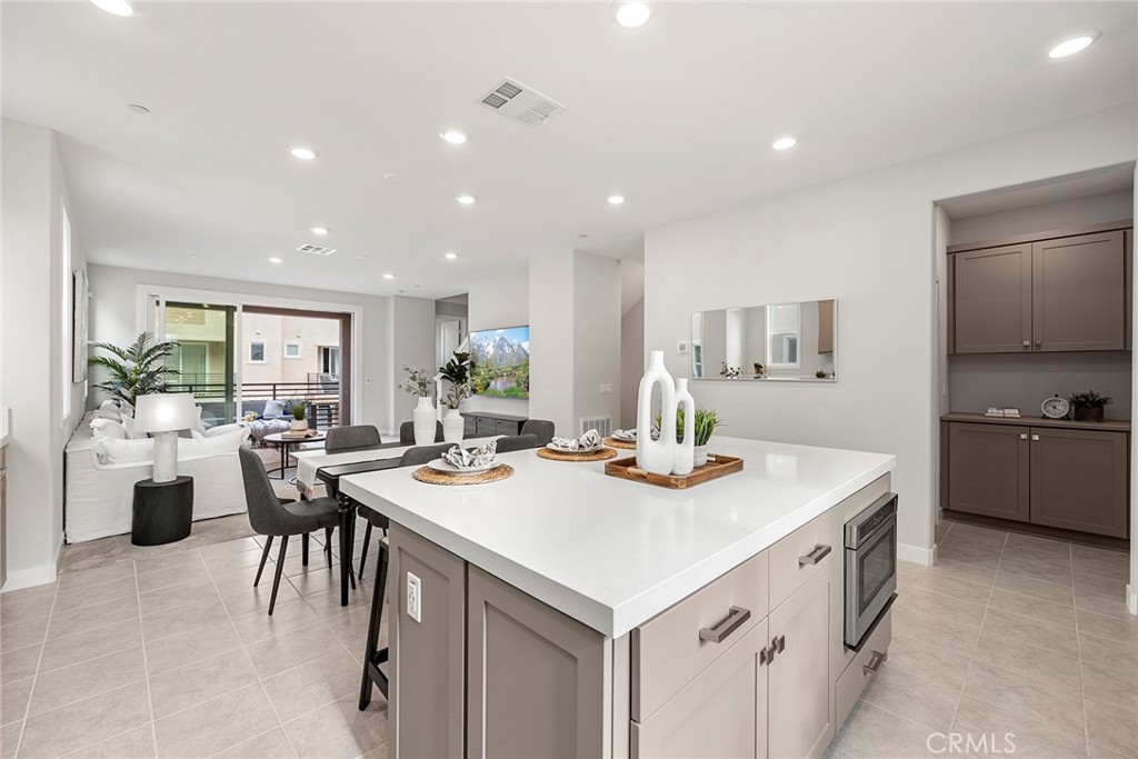 125 Pattern Irvine, CA 92618 - Photo 14 of 38 a kitchen that has a lot of cabinets a sink and wooden floor