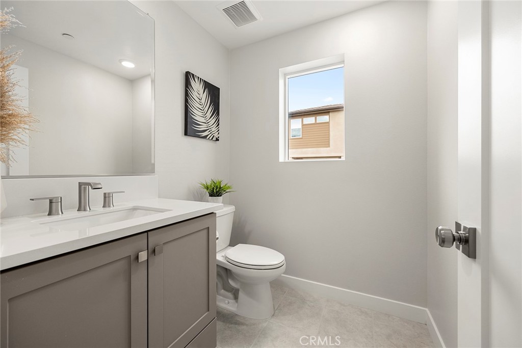 125 Pattern Irvine, CA 92618 - Photo 24 of 38 a bathroom with a granite countertop sink a toilet and a mirror
