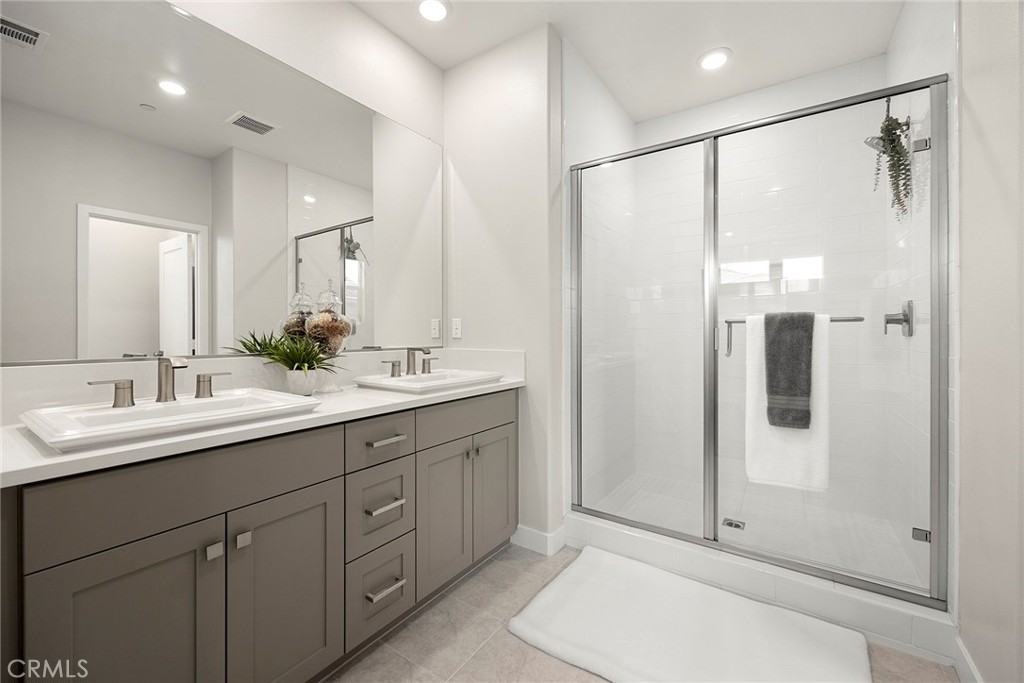 125 Pattern Irvine, CA 92618 - Photo 31 of 38 a bathroom with a double vanity sink mirror and shower