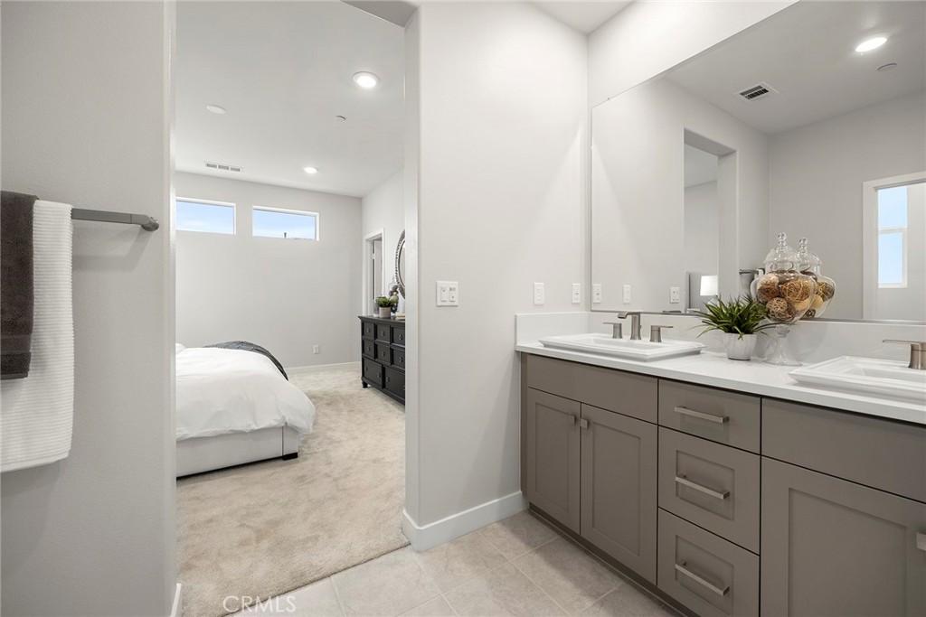 125 Pattern Irvine, CA 92618 - Photo 32 of 38 a en suite bathroom with a double vanity sink and mirror