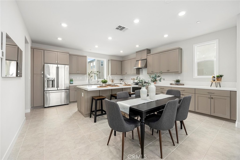 125 Pattern Irvine, CA 92618 - Photo 10 of 38 a kitchen with refrigerator a sink and chairs