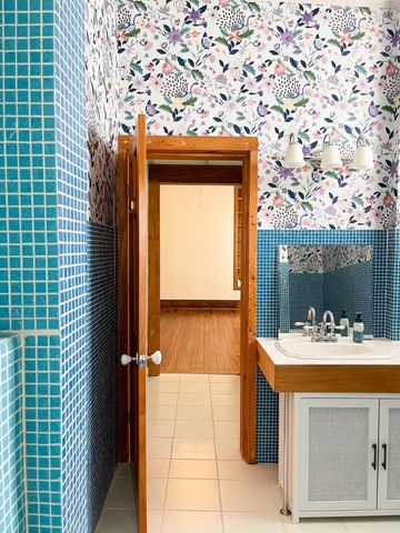 a bathroom with a sink a toilet and a mirror