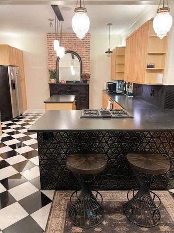 a kitchen with stainless steel appliances granite countertop a sink a stove and a refrigerator