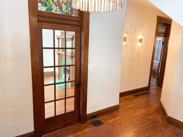an empty room with wooden floor and a window