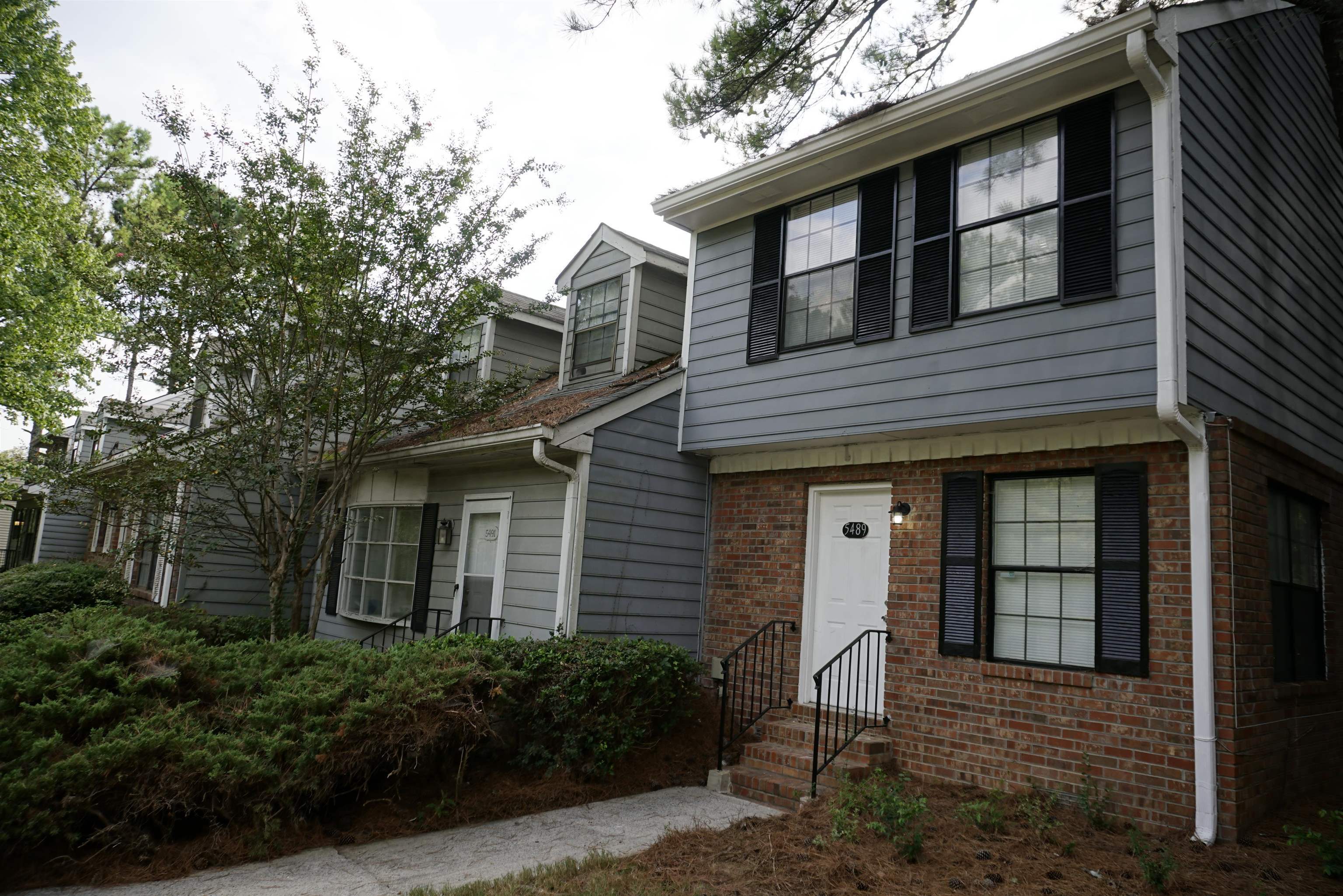5489 South Park Place Atlanta, GA 30349 - Photo 1 of 37 a front view of a house with a garden