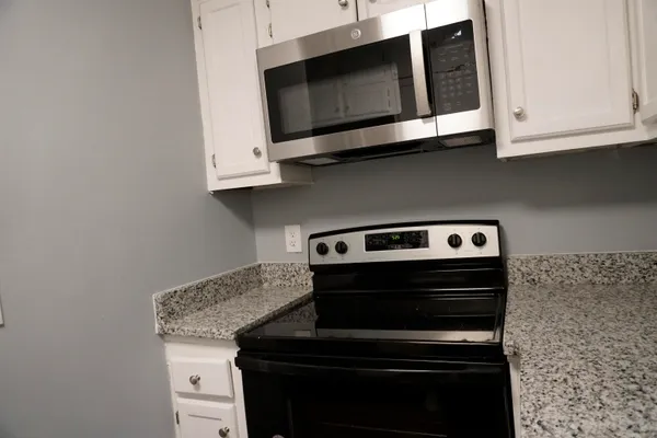 a stove top oven sitting inside of a kitchen