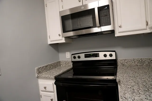 a stove top oven sitting inside of a kitchen