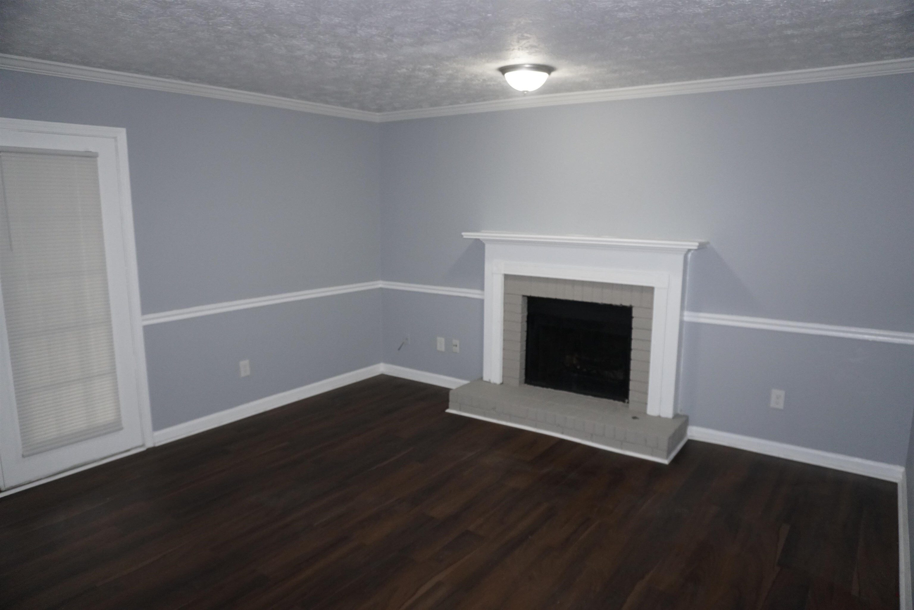 5489 South Park Place Atlanta, GA 30349 - Photo 16 of 37 a view of an empty room with wooden floor and a fireplace