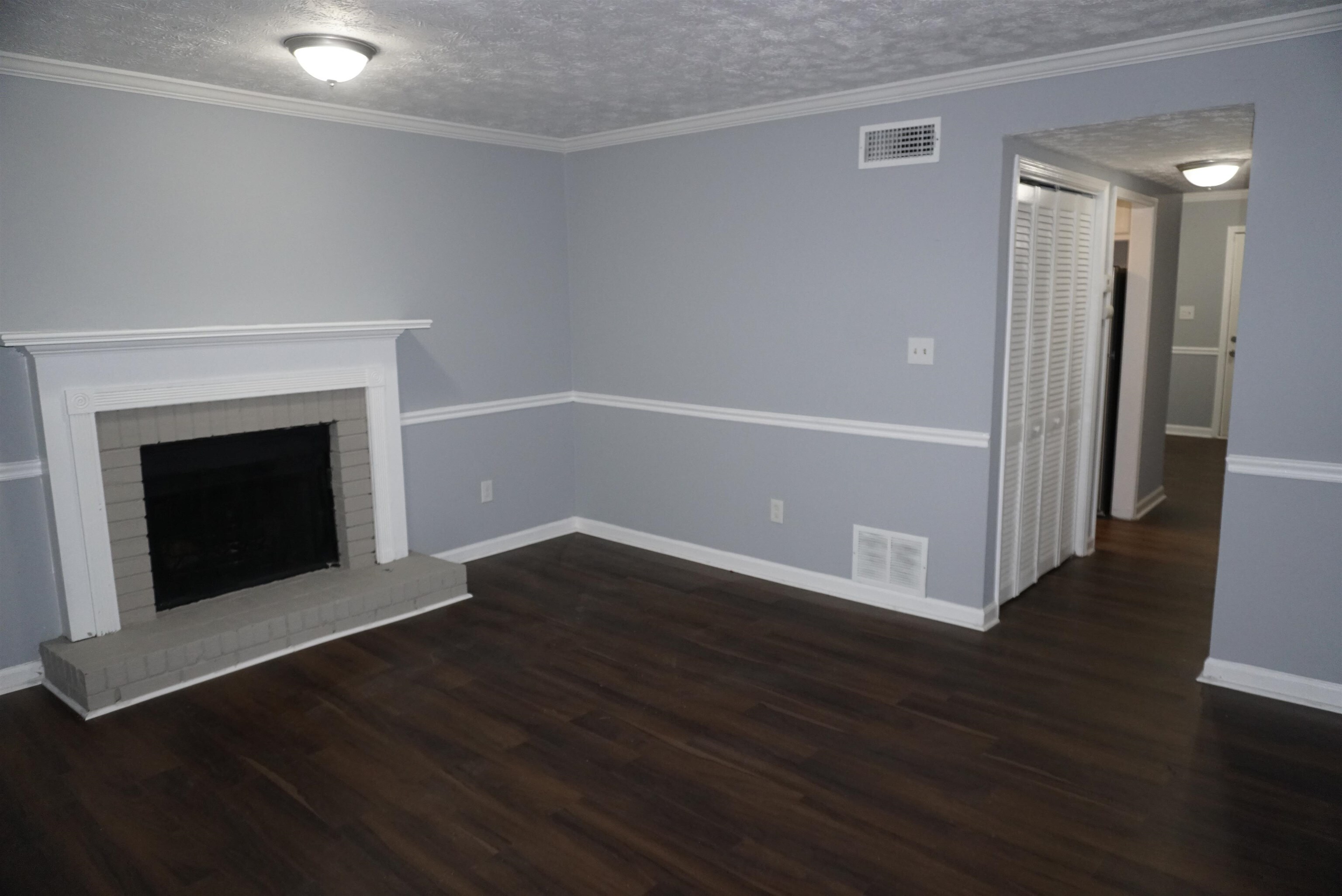 5489 South Park Place Atlanta, GA 30349 - Photo 19 of 37 an empty room with wooden floor and fireplace
