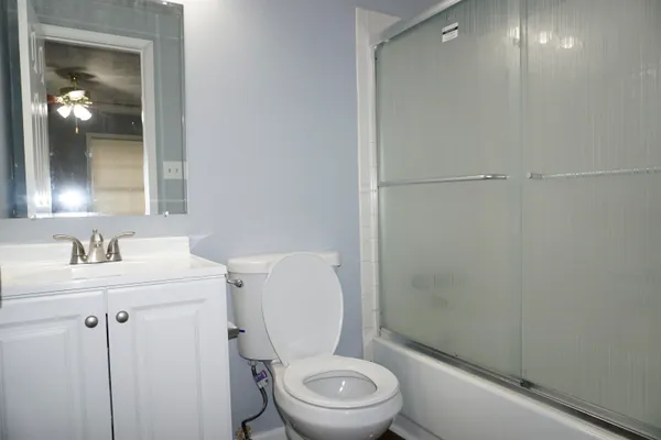 a white toilet sitting next to a bathroom sink