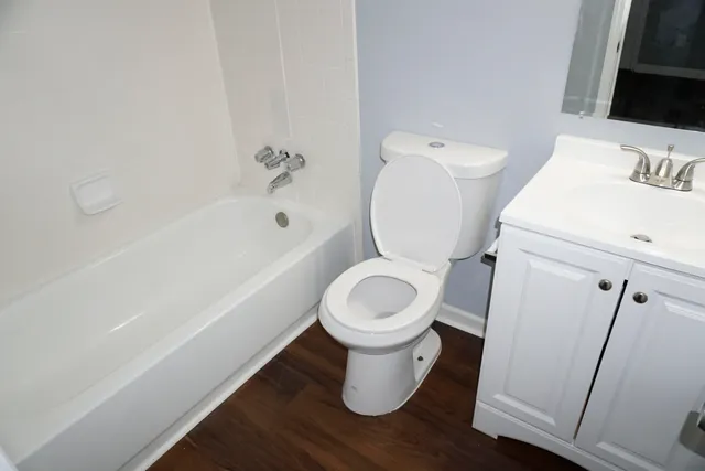 a white toilet sitting next to a bathroom sink