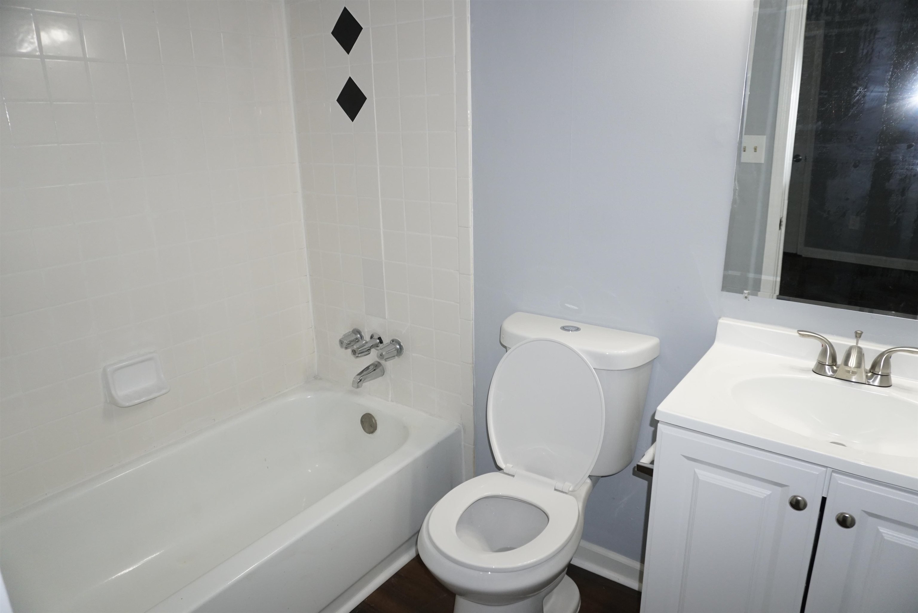 5489 South Park Place Atlanta, GA 30349 - Photo 31 of 37 a white toilet sitting next to a bath tub