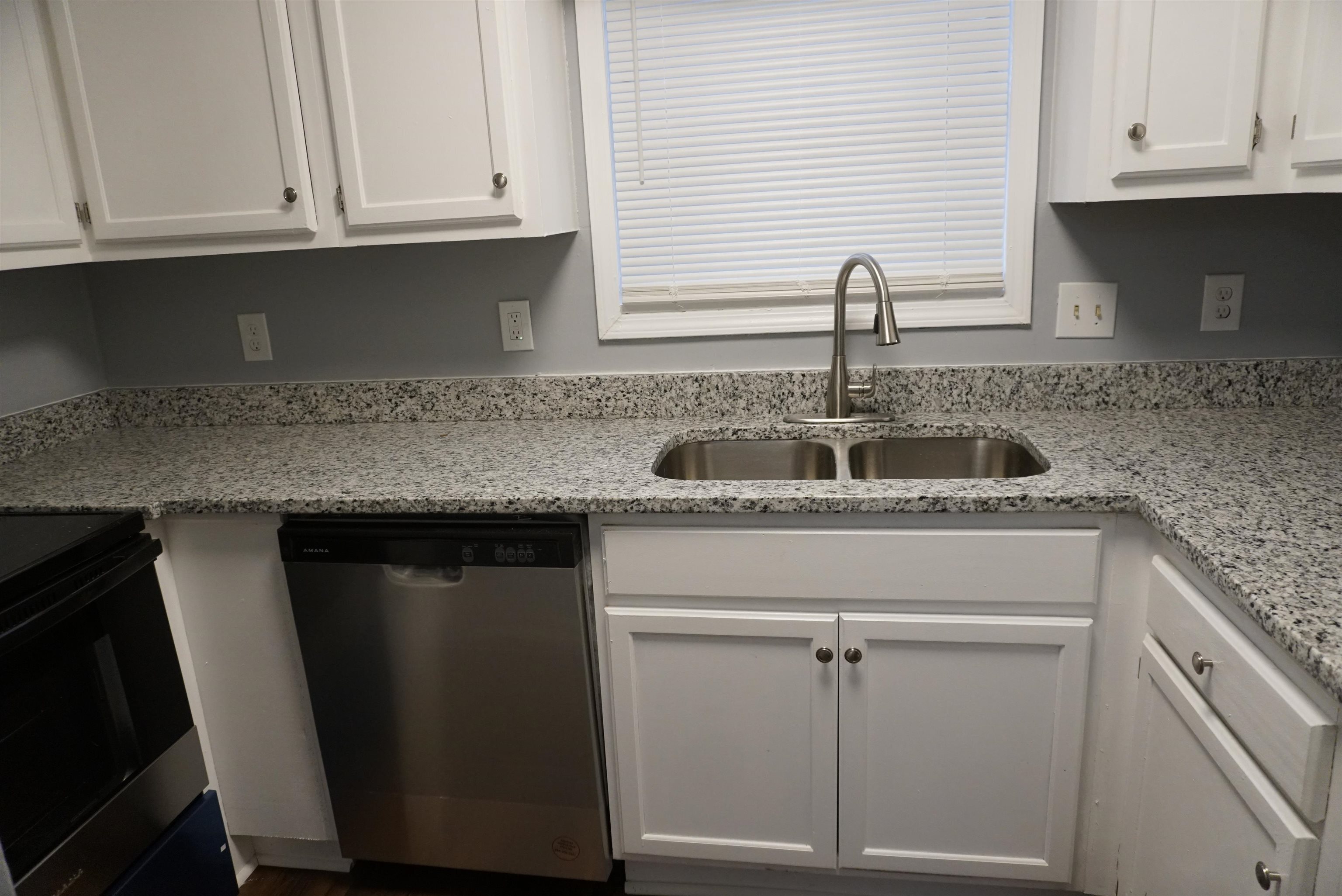 5489 South Park Place Atlanta, GA 30349 - Photo 10 of 37 a kitchen with granite countertop a sink and cabinets