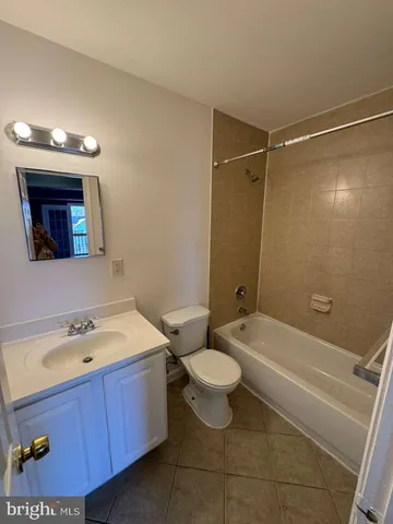 a bathroom with a sink toilet a mirror a bathtub and shower