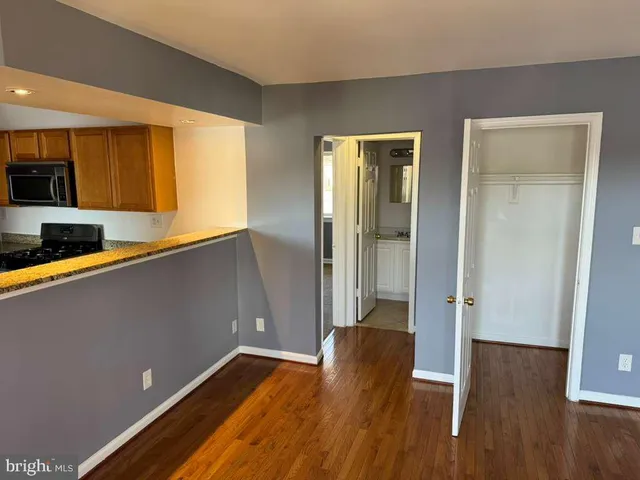 a view of room with window and wooden floor