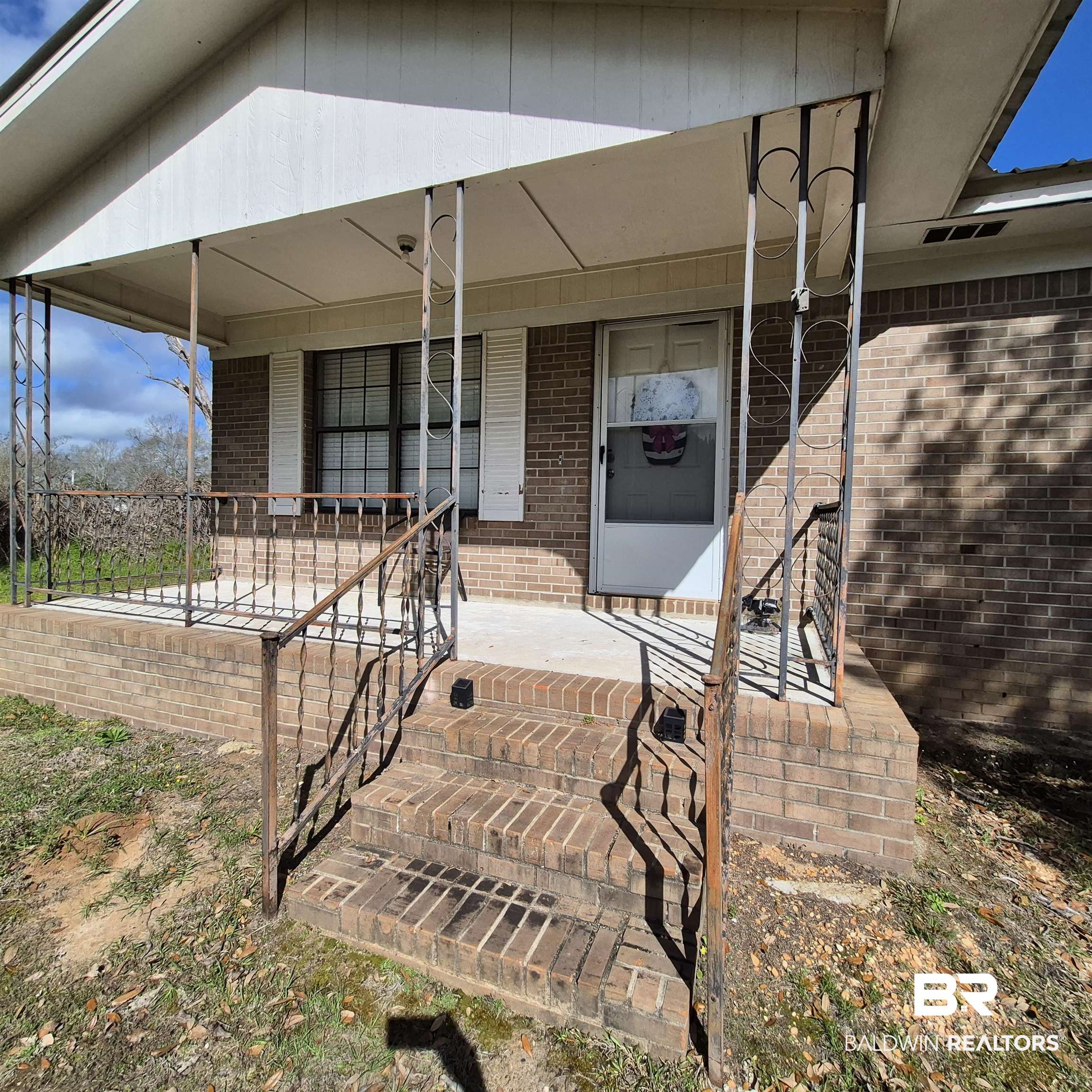 721 Perryman Street Evergreen, AL 36401 - Photo 25 of 26 Entrance to property with a porch and brick siding