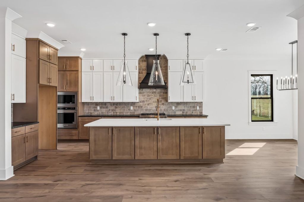 5133 Rambler Loop Franklin, TN 37064 - Photo 12 of 20 a large kitchen with stainless steel appliances kitchen island a large island in the center