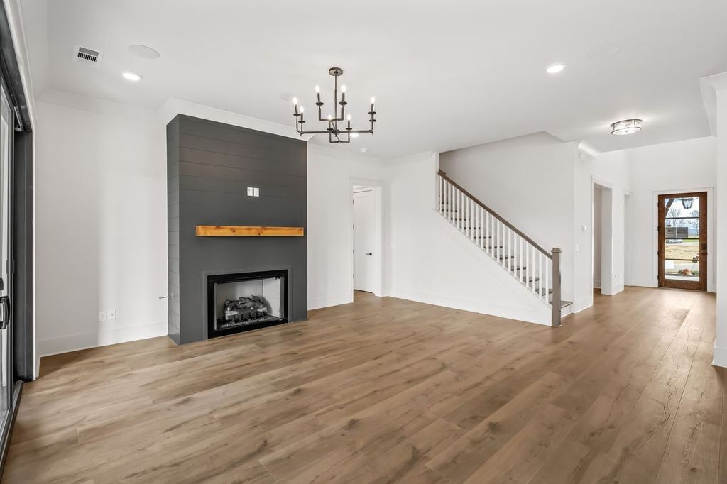 5133 Rambler Loop Franklin, TN 37064 - Photo 13 of 20 wooden floor with fireplace and windows