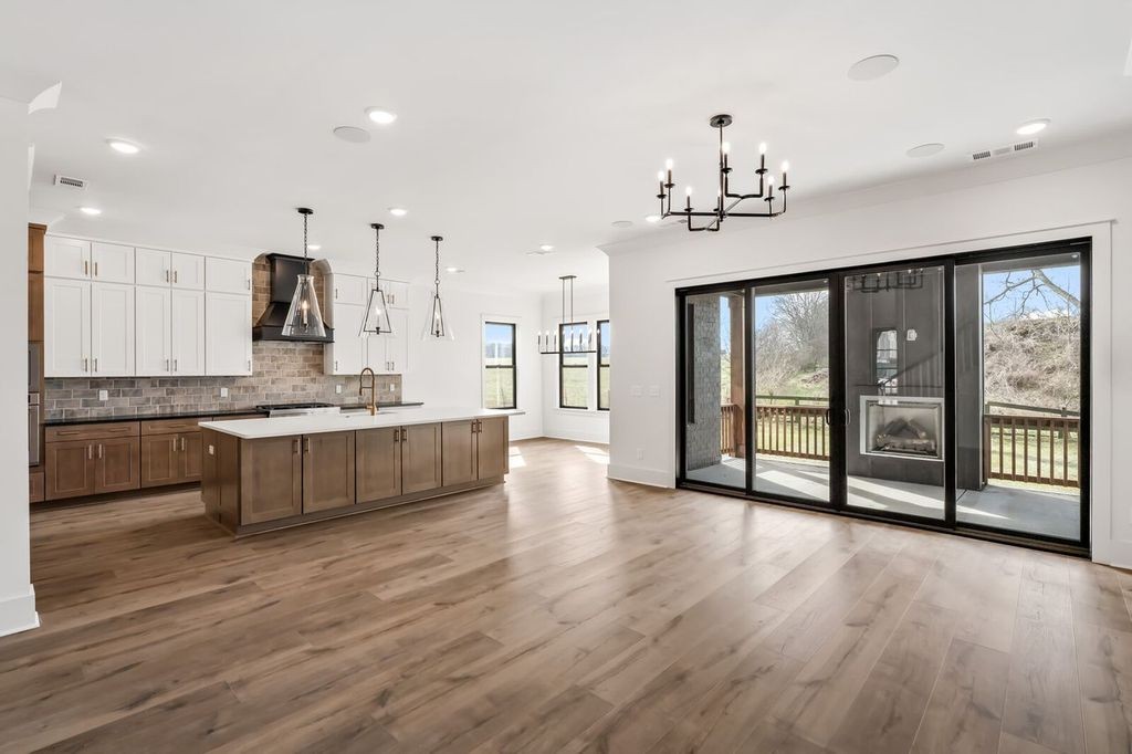 5133 Rambler Loop Franklin, TN 37064 - Photo 7 of 20 a large kitchen with stainless steel appliances a large counter top a stove and a wooden floors