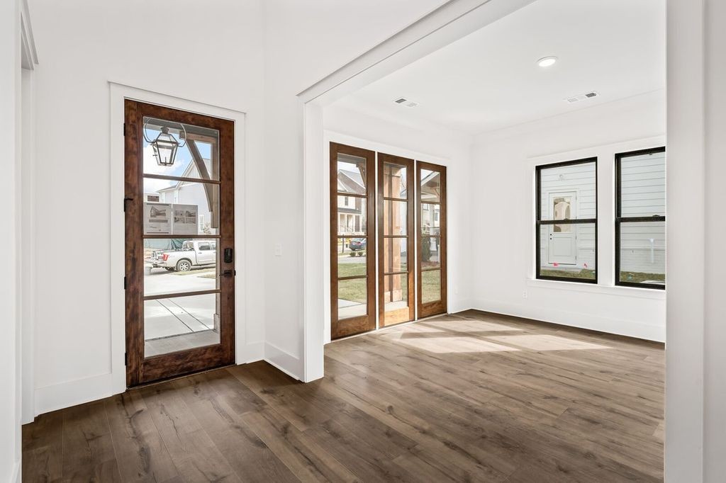 5133 Rambler Loop Franklin, TN 37064 - Photo 9 of 20 an empty room with wooden floor and windows