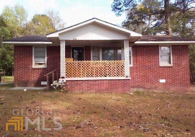 4716 Wilson Road Macon, GA 31206 - Photo 1 of 1 a front view of a house with a yard and garage