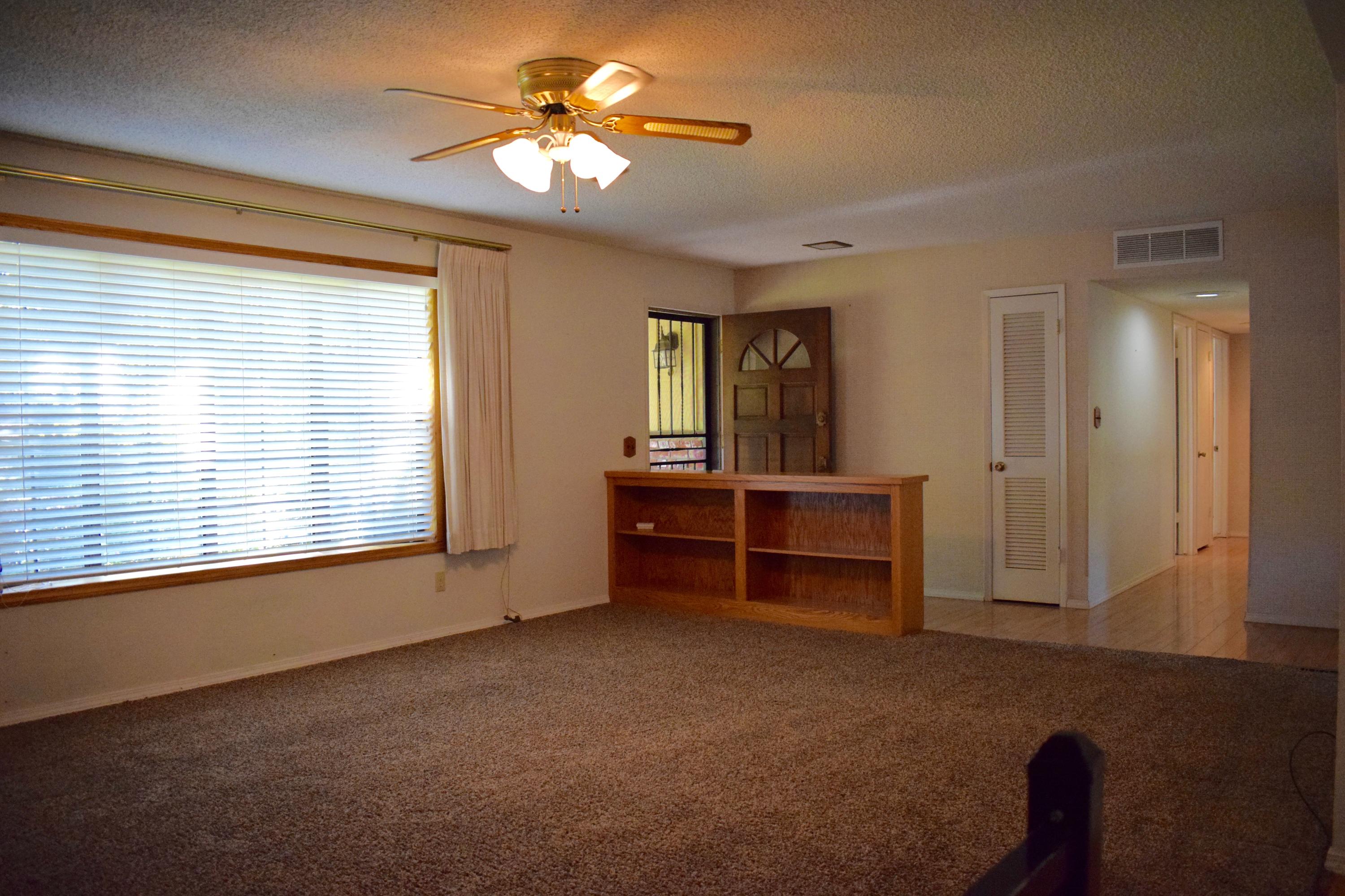 8585 Redbank Road Redding, CA 96001 - Photo 12 of 37 a view of room with chandelier fan and windows