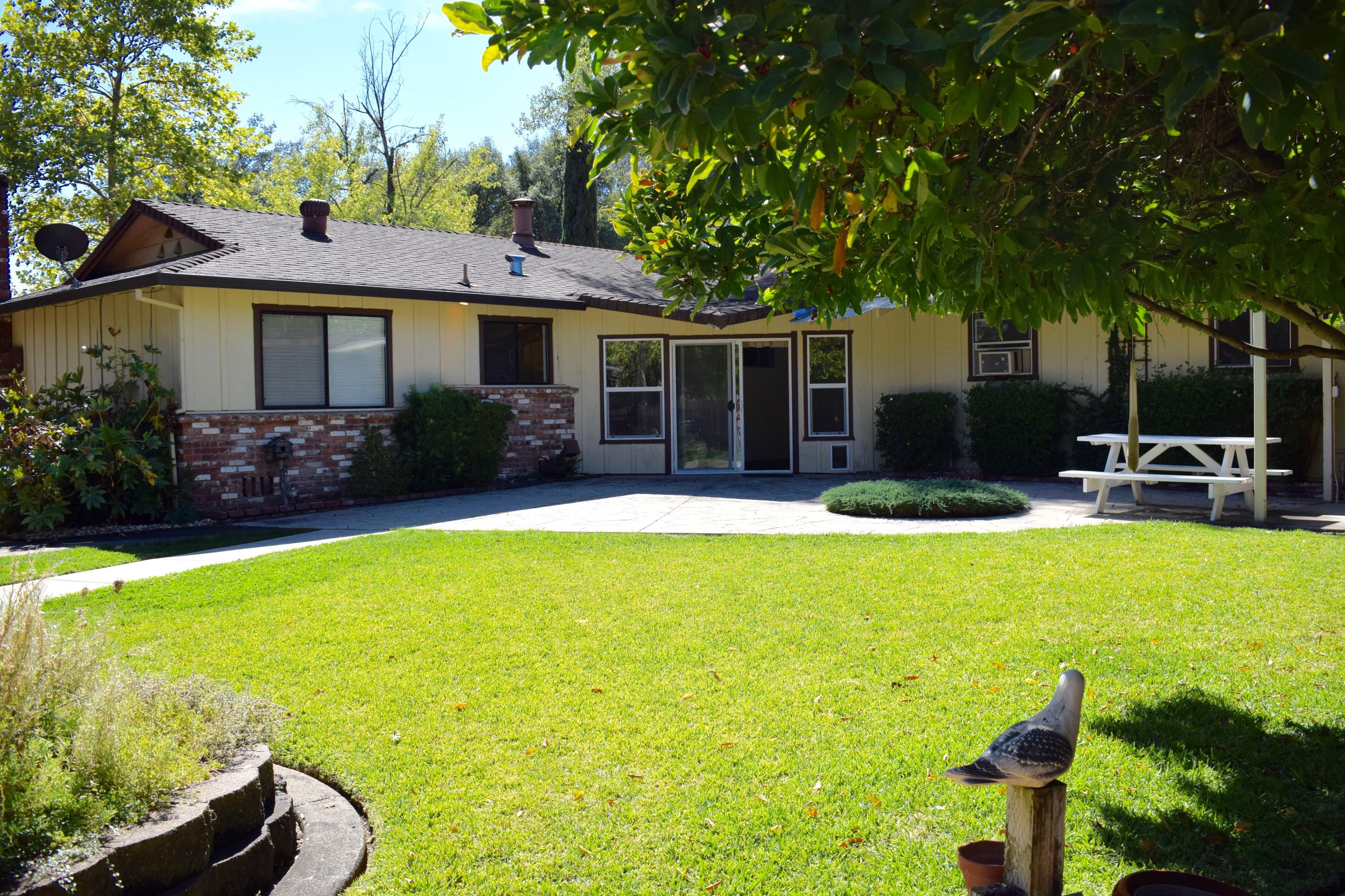 8585 Redbank Road Redding, CA 96001 - Photo 23 of 37 a front view of house with yard and outdoor seating