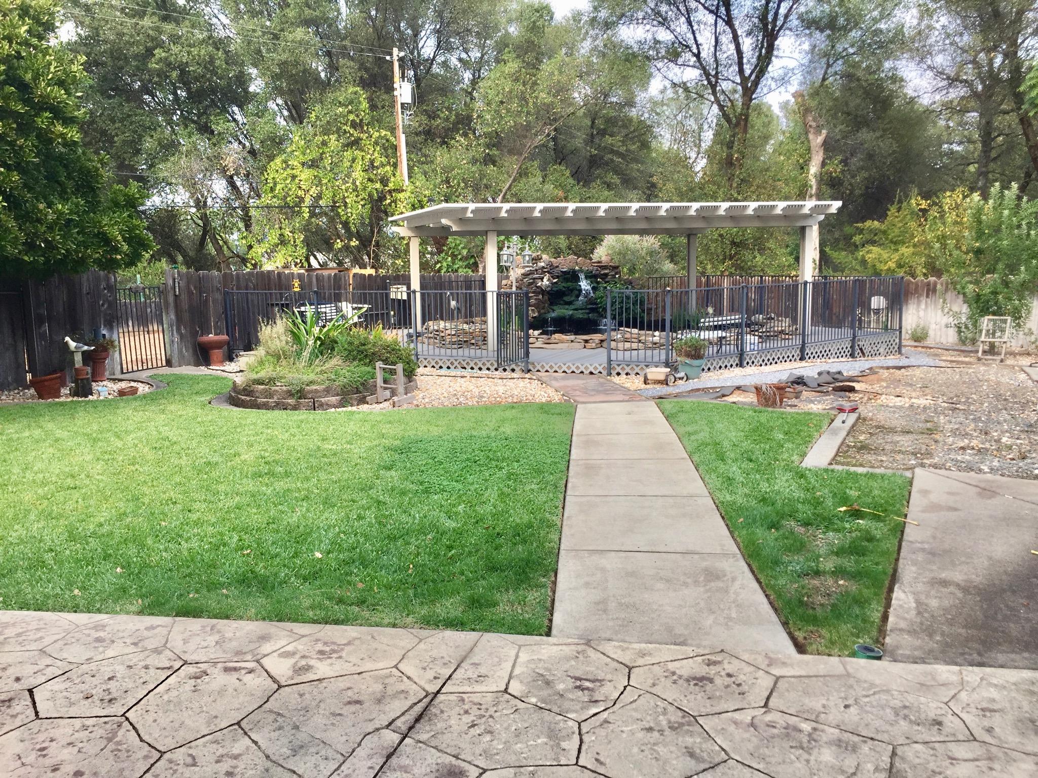 8585 Redbank Road Redding, CA 96001 - Photo 5 of 37 a view of a backyard with sitting area and furniture