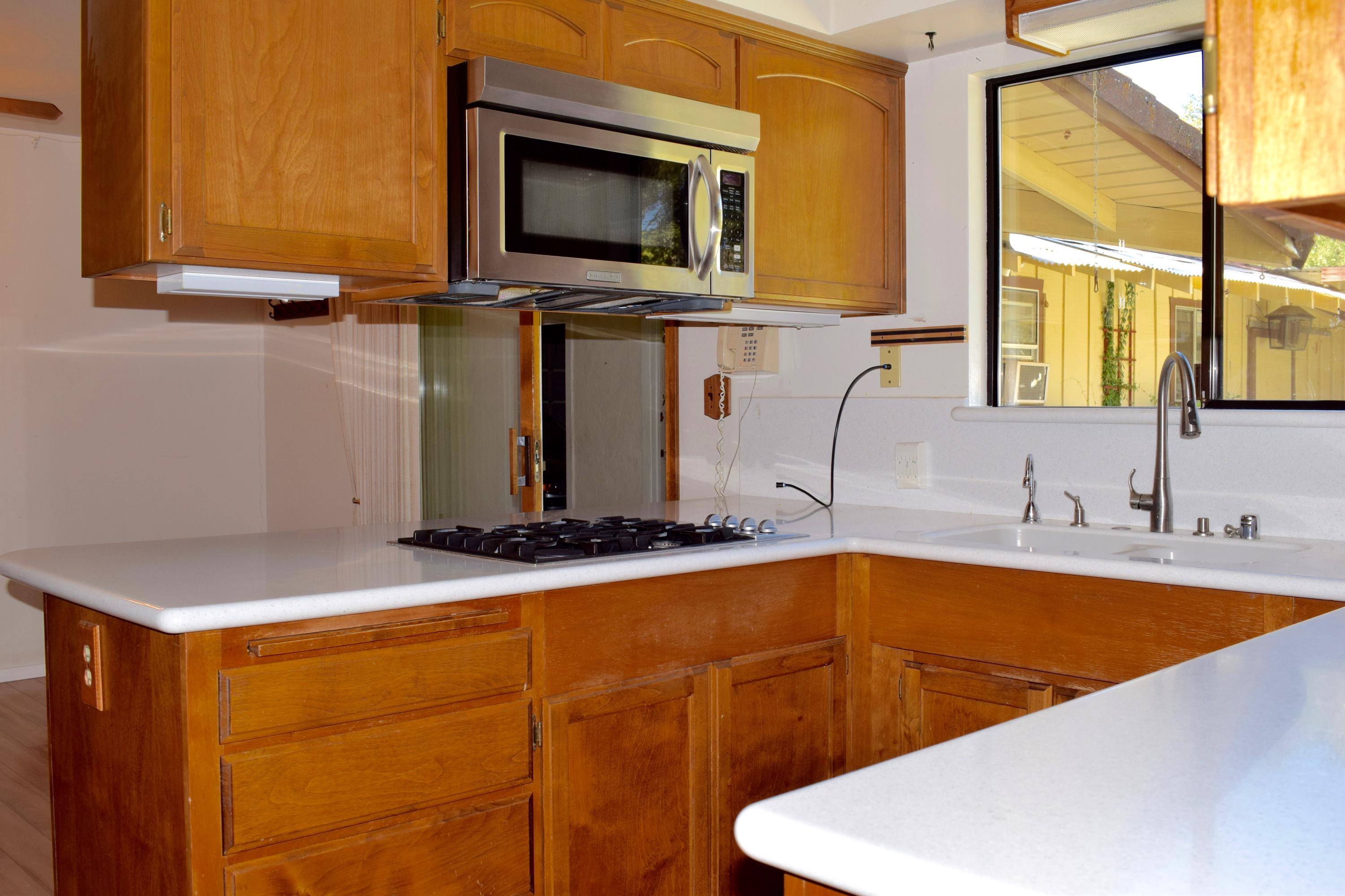 8585 Redbank Road Redding, CA 96001 - Photo 7 of 37 a kitchen with stainless steel appliances a sink and a microwave