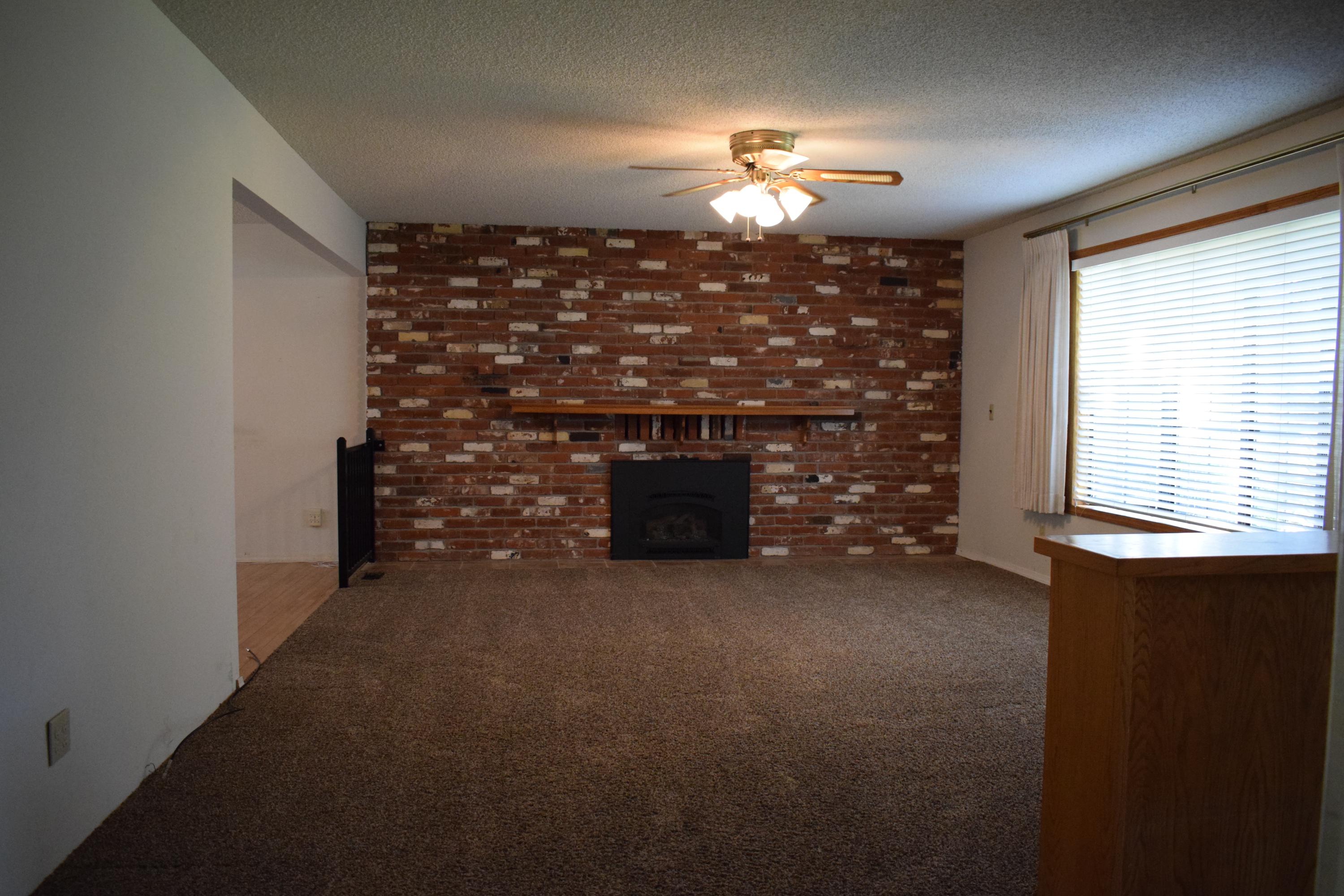 8585 Redbank Road Redding, CA 96001 - Photo 9 of 37 a view of empty room with a fireplace