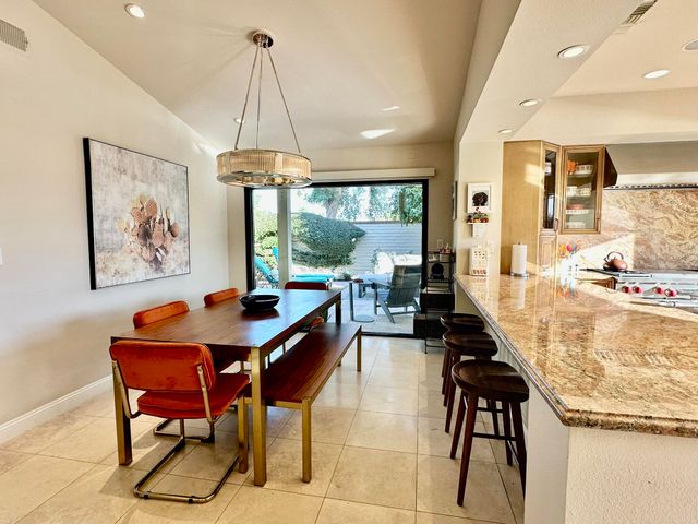 a dining table chair next to a window