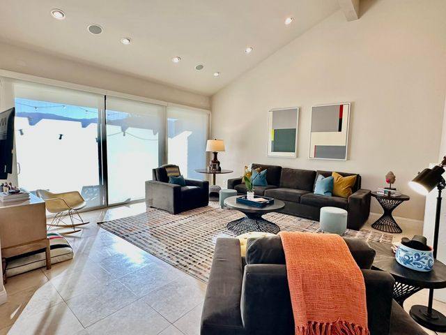 a living room with furniture a fireplace and a table