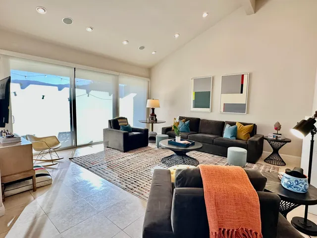 a living room with furniture a fireplace and a table