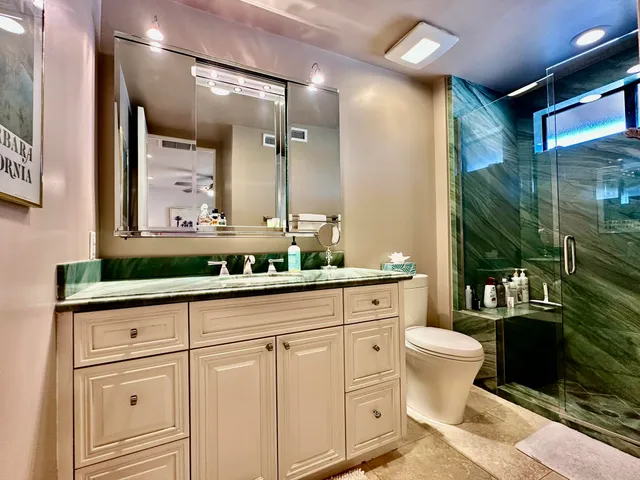 a bathroom with a shower toilet and sink