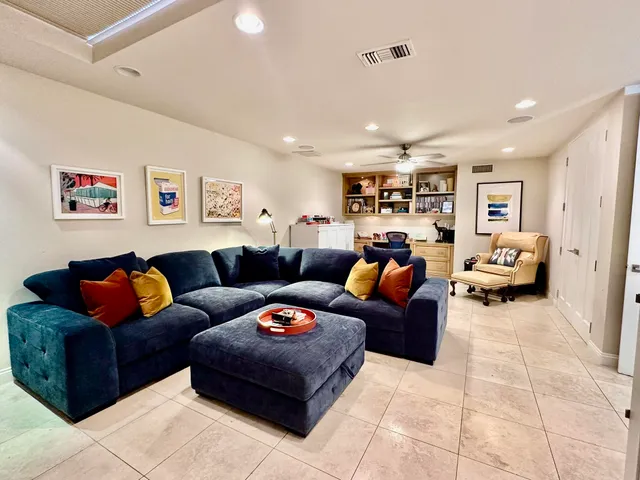a living room with furniture and kitchen view
