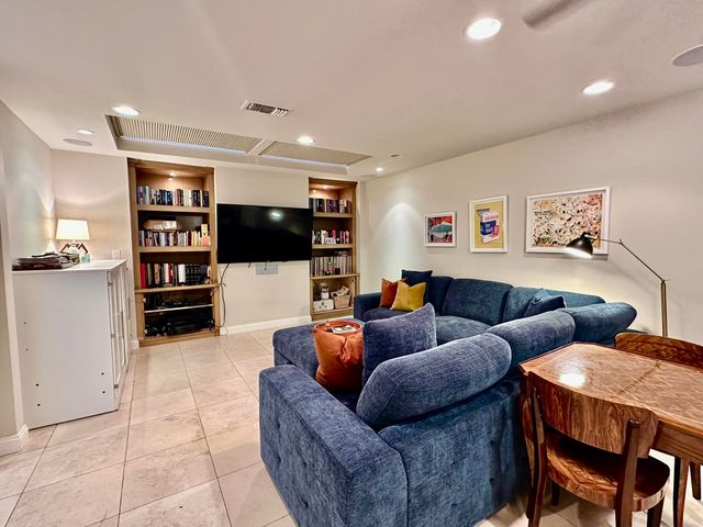a living room with furniture and workspace
